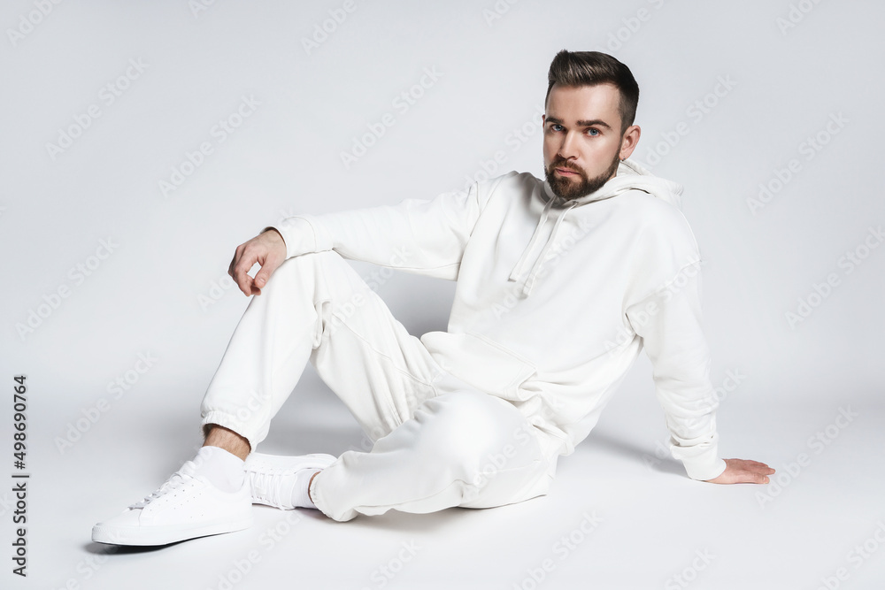 Wall mural Handsome man wearing blank white hoodie and pants