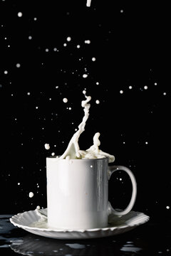 Cup with milk splashes in motion