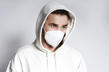 Young man wearing white hoodie and ffp2 respirator mask