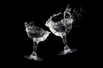 Cheers with two wine glasses isolated on black