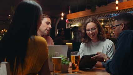 diverse group of work colleagues having meeting in restaurant 