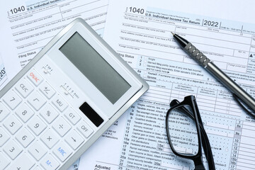 Calculator, glasses and pen on documents, flat lay. Tax accounting