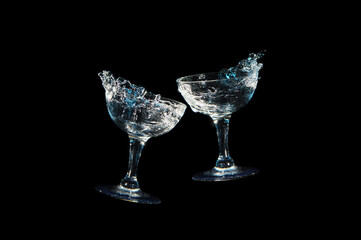 Toast with two wine glass in blue light and white light, isolated on black background