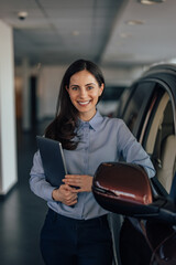 Portrait of delighted caucasian woman, carrying laptop in hands,