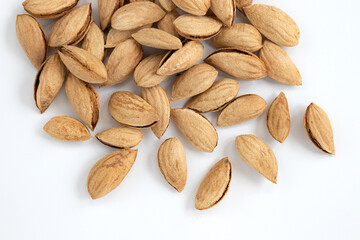 unpeeled almonds isolated on white background, top view
