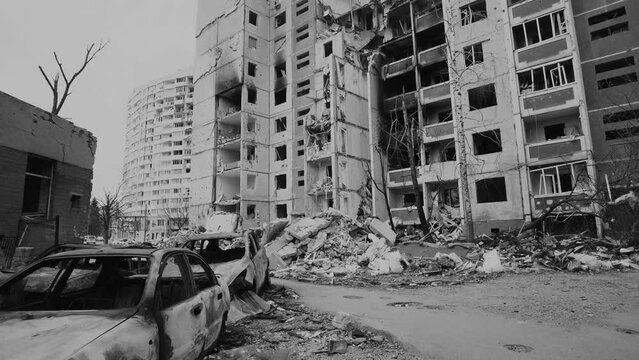 Damaged ruined and burnt out multi-storey house in ukrainian city Chernihiv near Kyiv on north of Ukraine. Ruins during War of Russia against Ukraine. Walls of ruined residential building. Black white