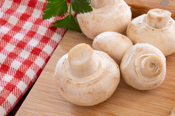 fresh whole mushrooms on the wooden board