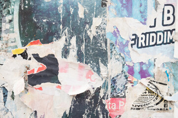 Ripped street posters collage on a retro wall background 