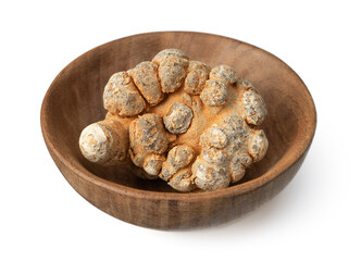 Dried notoginseng roots in the wooden bowl, isolated on the white background.