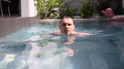 Successful Man Swimmer swimming in Swimming Pool.