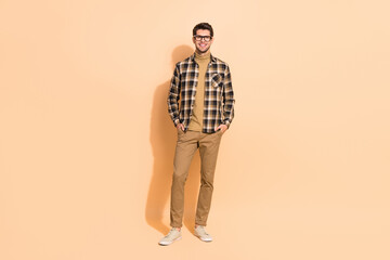 Full length body size view of attractive content intellectual guy holding hands in pockets isolated...