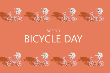 Decorative bicycles with flowers and text World Bicycle day on orange background