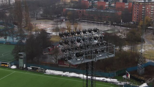 Aerial orbit approach shot of huge soccer arena spotlights