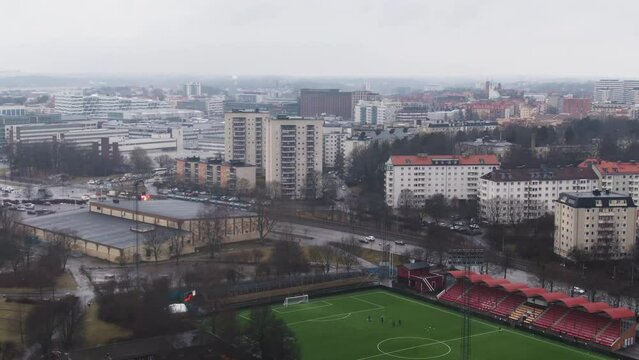 Aerial tilt down from Solna skyline to soccer pitch
