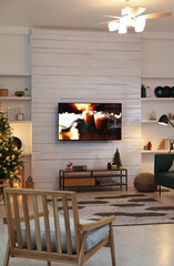 Plasma TV on white wooden wall in living room beautifully decorated for Christmas