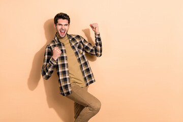 Photo of delighted millennial guy win fortune luck lottery fist up shout yeah isolated pastel color background