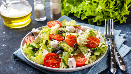 Vegetable salad on a plate served with fork and knife. Healthy and diet food concept
