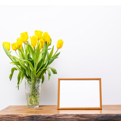 Empty frame mockup with tulip flowers.
