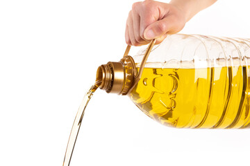 Pouring a bottle of cooking oil isolated on white background
