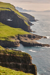 Helicopter flying over mykines atlantic cliffs in Faroe islands. Transportation