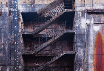 Part of a dry dock wall with a concrete staircase.