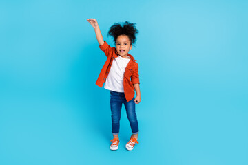 Full body image of adorable little woman measure her height wish to be taller isolated on blue color background