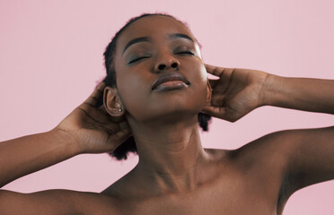 Posing for a camera. Portrait of young african american woman that is against pink background