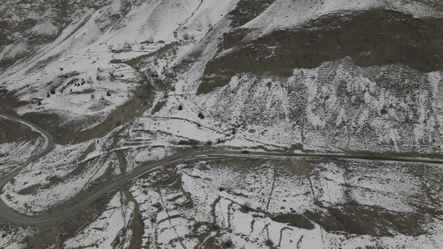 road in the mountains with snow mountain in background in autumn season.