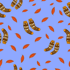 Autumn seamless pattern on a blue background with cozy socks and autumn leaves. Hand drawn autumn socks and leaves. Texture for scrapbooking, wrapping paper, invitations.