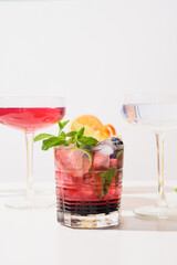 Blackberry mojito cocktail with lime and mint. Summer freshness beverage for festive party a white...