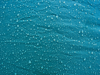 Obraz na płótnie Canvas Water drops on waterproof membrane fabric. Morning dew on tent.