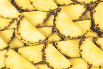Pineapple juicy yellow slices background. Top view.