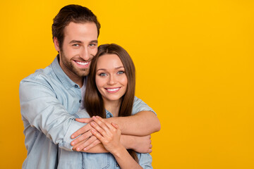 Photo of sweet young brown hairdo couple hug wear blue shirt isolated on yellow background