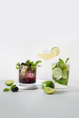 Classic and blackberry mojito, margarita cocktail with lime on modern color background. Summer freshness beverage for festive party.