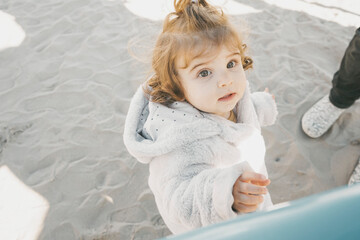 Fototapeta premium Portrait of a little girl in a winter sunny day