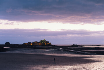 Fototapeta na wymiar Elizabeth Castle with low tide at sunset. Jersey, United Kingdom