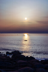 Silhouette of small boat on the Atlantic ocean during sunset