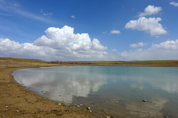 wonderful spring landscape of sky lake and clouds,clouds reflecting in water,