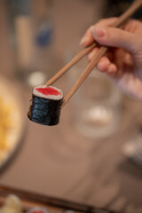 Fototapeta na wymiar Sushi eating with a chopstick in hand