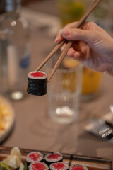 Sushi eating with a chopstick in hand
