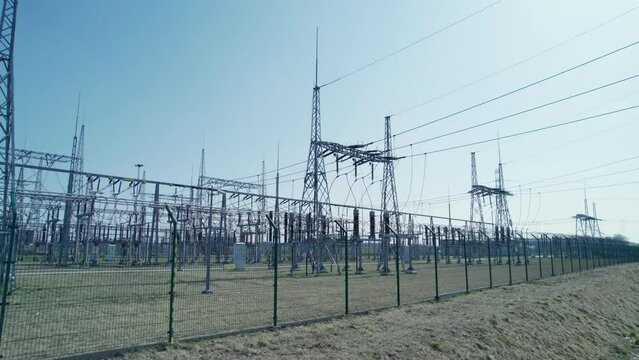 Transformer station, energy security of countries. A power station surrounded by barbed wire and monitored by industrial cameras.