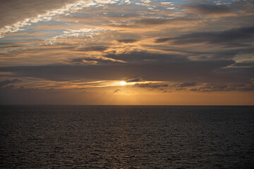 Calm ocean water. Sunset at sea landscape. Dramatic sunset sky with clouds. Dramatic sunset over the sea.