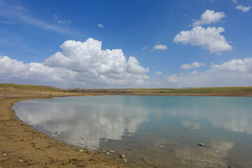 wonderful spring landscape of sky lake and clouds,clouds reflecting in water,