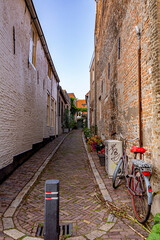 Peaceful empty narrow street with a bicycle in old town center of Bergen op Zoom