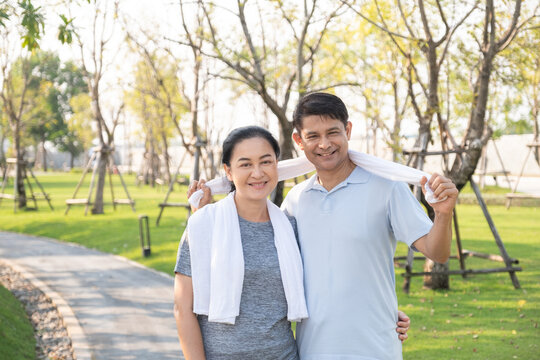 A Happy Retired Senior Asian Couple Smiling And Looking At The Camera Look Like Very Happy In The Park.