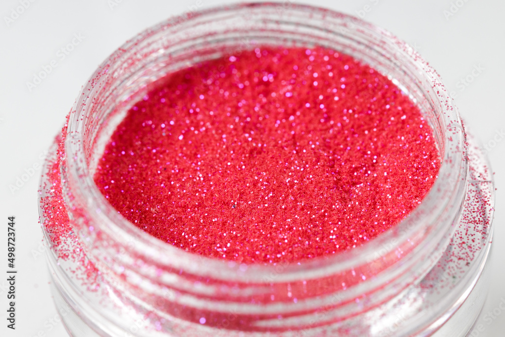 Poster colored sequins in a plastic jar close-up