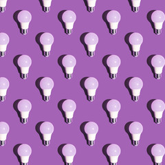 Pattern made of led bulb lamp on pastel purple background. Top view, copy space. Energy saving idea