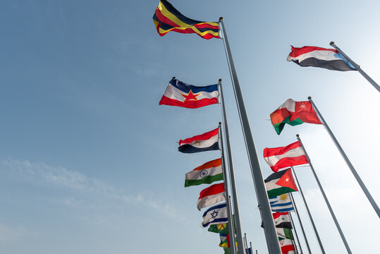 Flags of many countries on flagpoles, international cooperation concept