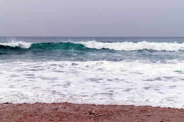 Ocean waves energy, breaking waves. Surfing waves, swell and wave direction. On shore view to ocean waves breaking. Ocean coast backgrounds. 