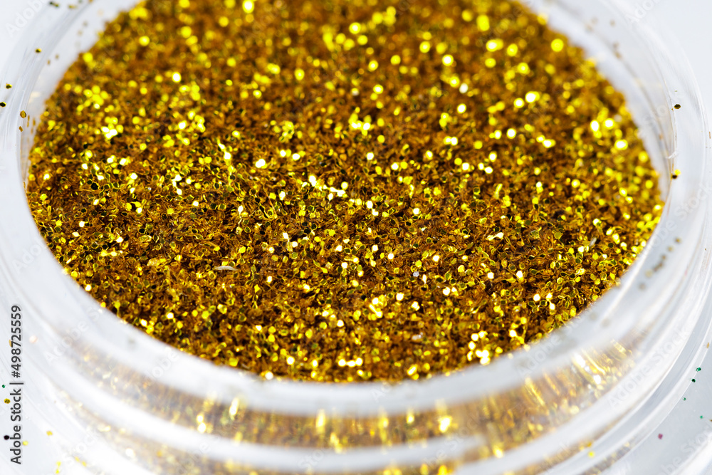 Poster colored sequins in a plastic jar close-up
